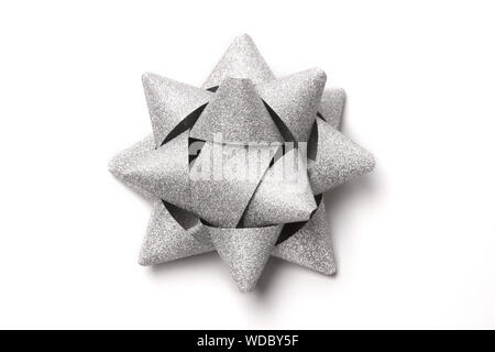 Silver glitter gift bow isolated on white. Stock Photo