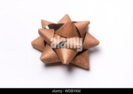 Golden glitter gift bow isolated on white. Stock Photo