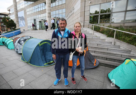 Homeless couple Wesley Condon and Sintija Klava, who lived in a tent for two years, pass an Inner City Helping Homeless protest outside Dublin City Council Offices on Wood Quay to highlight a marked increase in the number of people living in tents over the last month and the plight of homelessness. Stock Photo