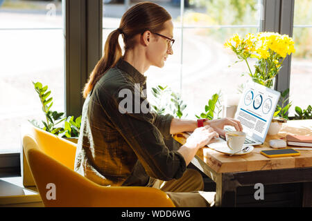 Serious young man looking at the analytics Stock Photo