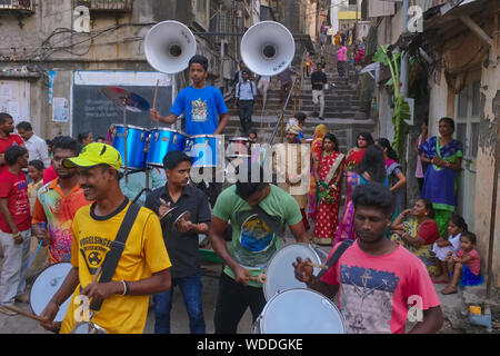 During a low-key Indian wedding, an amateur wedding band play in a backyard in Mumbai, India, with the couple and friends looking on in the background Stock Photo