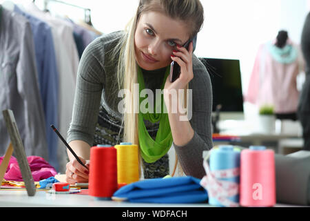 Clothes Design and Retail Designer Talking Phone Stock Photo