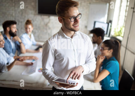 Happy creative team in office. Business, startup, design, people and teamwork concept Stock Photo