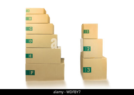 Cardboard parcel boxes stacked on each other at white background Stock Photo