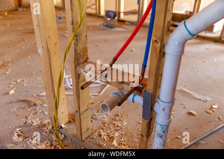 PEX plumbing and PVC pipe drain in new home construction Stock Photo