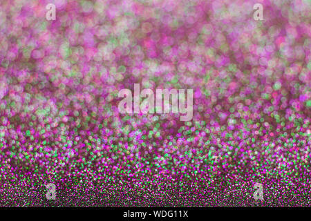 Abstract multicolored glitter background. Green and pink glitter bokeh. Stock Photo