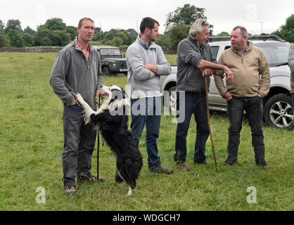 Gargrave Show Sheepdog Trials, Holme Farm Gargrave, North Yorkshire. Participants watch the sheepdog trials. Stock Photo