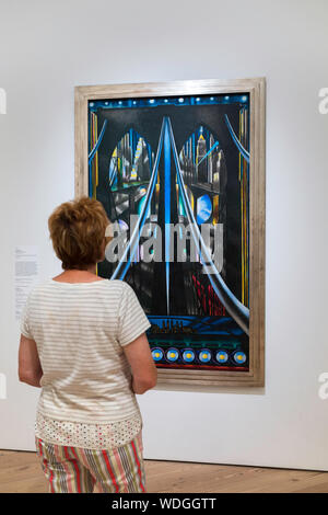 Joseph Stella, rear view of a mature woman looking at The Brooklyn Bridge (1939) by Joseph Stella inside the Whitney Museum Of American Art, NYC, USA Stock Photo