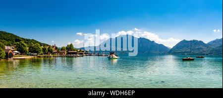 Beautiful view on Attersee lake im Salzkammergut, alps mountains, boat, sailboat in by Unterach. Upper Austria, nearby Salzburg. Stock Photo