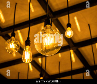 Set of realistic glowing lamp hanging on the wire. Incandescent lamp. Stock Photo