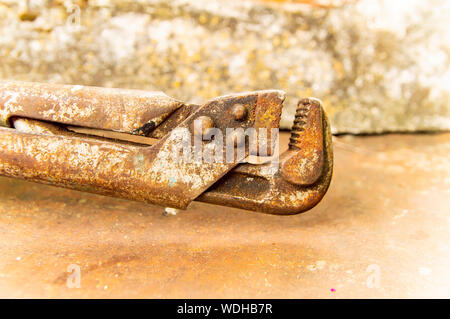 Old plumbing wrench - working tool. Background. Stock Photo