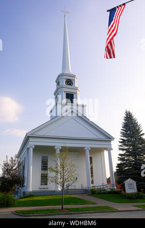 Stowe Community Church with the american flag flying overhead in the small northern New England town of Stowe, Vermont, USA Stock Photo