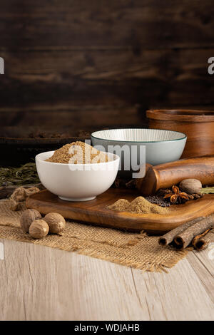 Ground coriander seed in a bowl and food preparation and kitchen setting Stock Photo