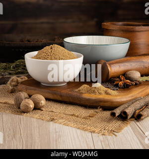 Ground coriander seed in a bowl and food preparation and kitchen setting Stock Photo