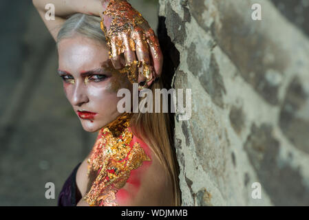 Girl in form of zombie, Halloween corpse with blood on lips. Image for horror film. Stock Photo