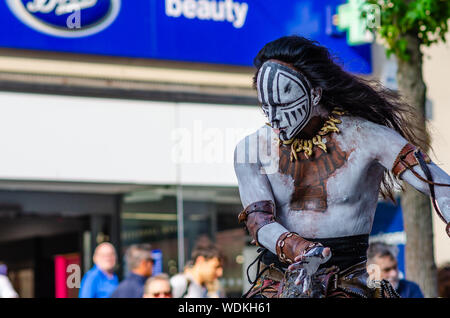 Emotional Maya dance performed by Mexican Ritual Maya theatre artist on the street of Liverpool. The artist wears the traditional Maya people costume. Stock Photo