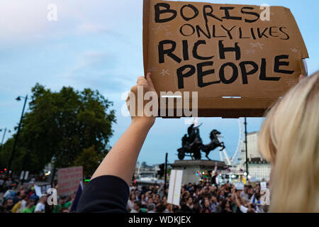 London, UK. 28th Aug, 2019. A protester holds high a placard during the demonstration.Hundreds protest against Boris Johnson outside the houses of parliament on Westminster Bridge. Credit: Lexie Harrison-Cripps/SOPA Images/ZUMA Wire/Alamy Live News