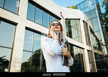 Middle age woman talking using a smartphone mobile phone Stock Photo