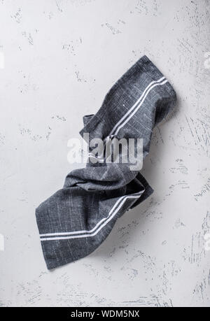 Gray linen napkin on light table Stock Photo
