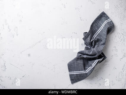 Gray linen napkin on light table Stock Photo