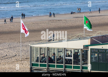 Walkers on the North Sea beach of Egmond aan Zee, North Holland, Netherlands, beach stalls, restaurants, cafes, Stock Photo