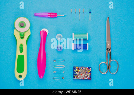 important sewing equipment photographed from above against blue background, Stock Photo