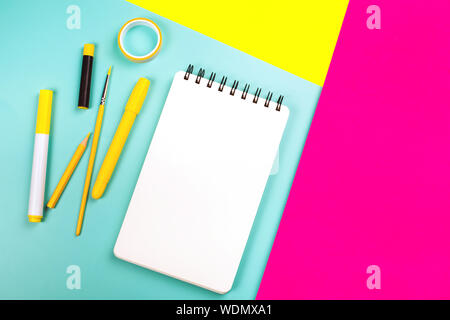 School supplies on yellow and pink background with copy space. Back to school concept. Stock Photo