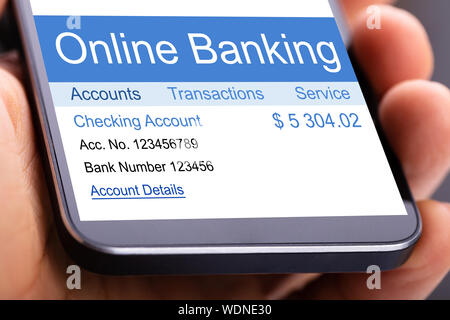 Close-up Of A Human's Hand Showing Online Banking On Mobilephone Stock Photo