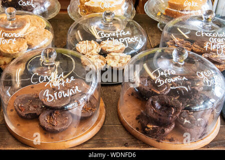 Tasty desserts on display in glass containers at a small bakery Stock Photo