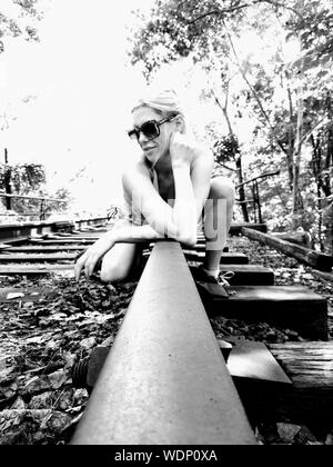 Woman Lying On Railroad Track