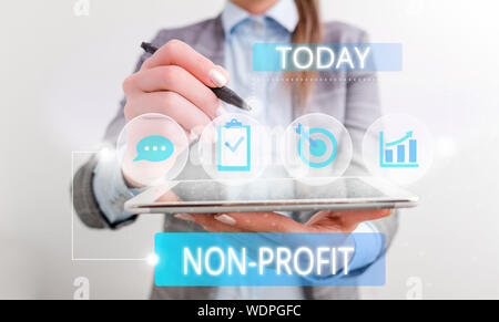 Conceptual hand writing showing Non Profit. Concept meaning type of organization that does not earn profits for its owners Female human wear formal wo Stock Photo