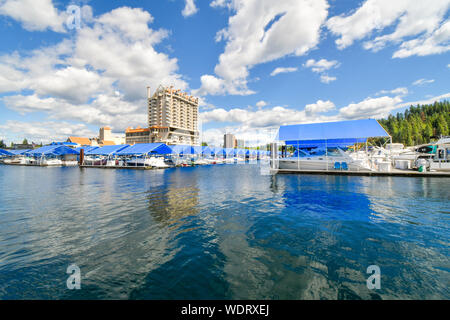 A view from the floating boardwalk of the marina full with boats and the Coeur d'Alene Resort on Lake Coeur d'Alene. Stock Photo