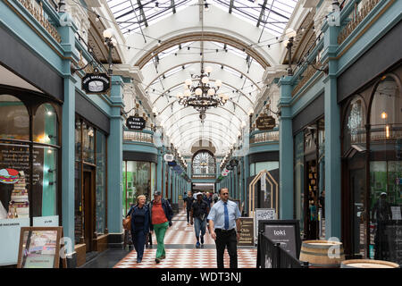 Shoppers in the Great Western Arcade - a covered Grade II listed Victorian shopping arcade with independent shops in Birmingham, England Stock Photo