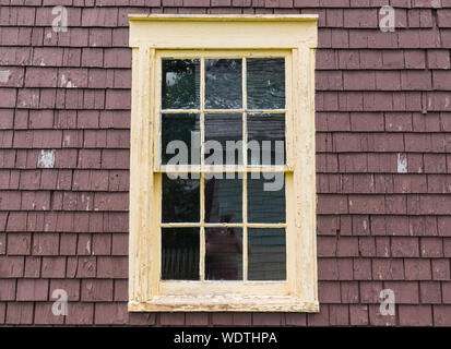 Old rustic yellow window frame with weathered peeling Stock Photo