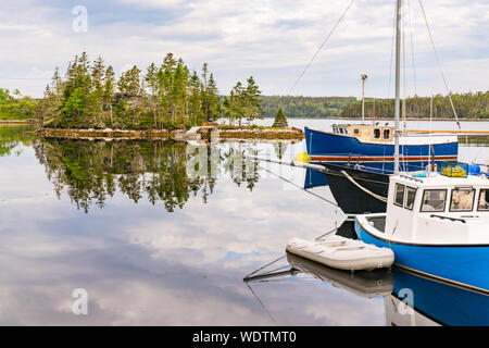 Old fishing boats in a cove in Nova Scotia, Canada Stock Photo