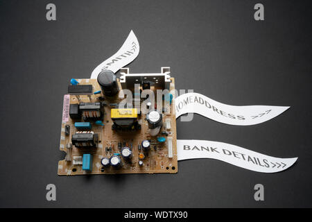 A circuit board with labels illustration data leaks, personal details and computer hacking in a big data warehousing world Stock Photo