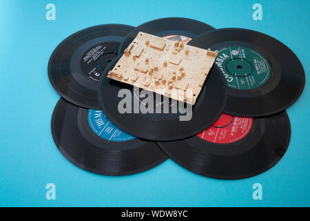 Old vinyl records with gold digital chip Stock Photo