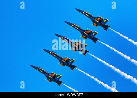 U.S. Navy Blue Angels flight demonstration team in the Line Abreast Loop formation. Stock Photo