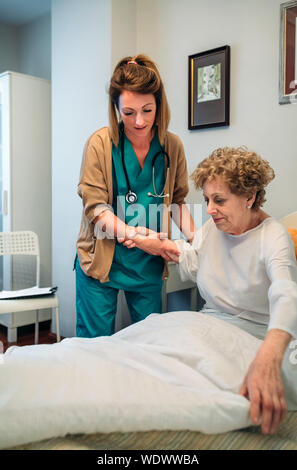 Nurse Caring For Patient Stock Photo - Alamy