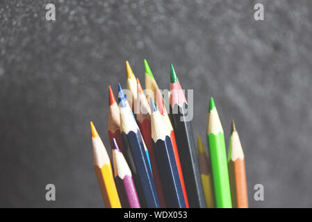 Colored pencil set on blackboard back to school and education concept / Crayons colorful Stock Photo