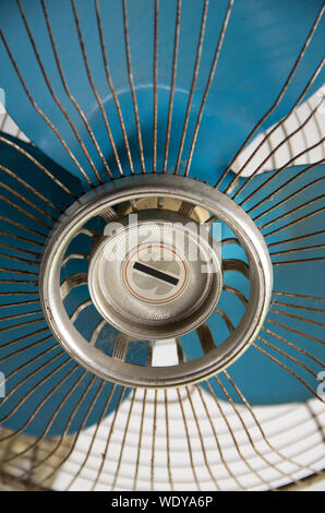 Vintage old white stand fan with blue blades Stock Photo