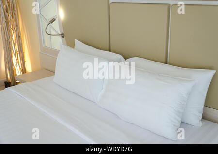 White pillows on a bed  in bedroom. Stock Photo