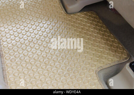 Cream color rubber carpet in car. The benefit of car carpets is not just the interior of the car to be beautiful. But can protect the car from wear, m Stock Photo