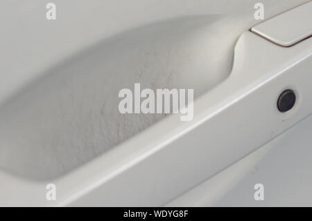 Scratches on car door handles white. Car door handle is an external part of the car. Stock Photo