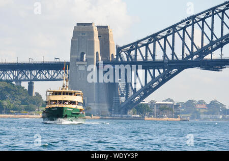 Beautiful scenic view of Sydney harbour with Manly ferry and Sydney harbour bridge in background on sunny day. Stock Photo