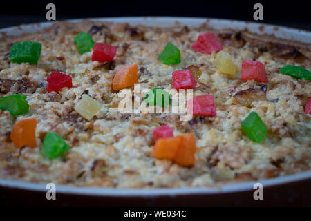 Homemade organic apple pie dessert ready to eat, close up. Apple tart with walnut and candied fruit. Stock Photo
