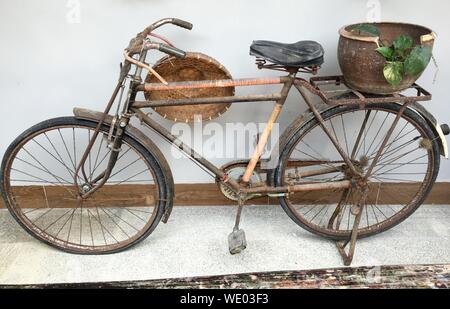 High Angle View Of Rusty Bicycle Parked Against Wall