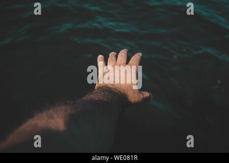 Cropped Image Of Hand Reaching Towards Wall Stock Photo Alamy