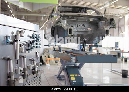 Car frame in a car manufacturing workshop. Collector Tools. Auto repair shop. Stock Photo