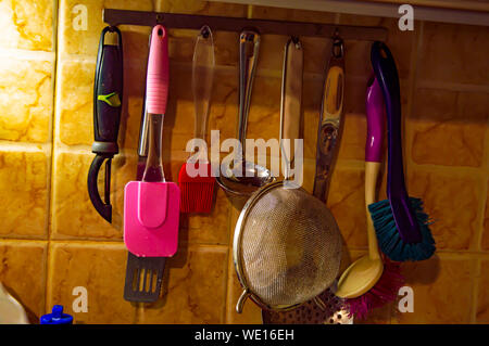 Kitchen tool hanging on the wall. Background image. Place for text. Stock Photo